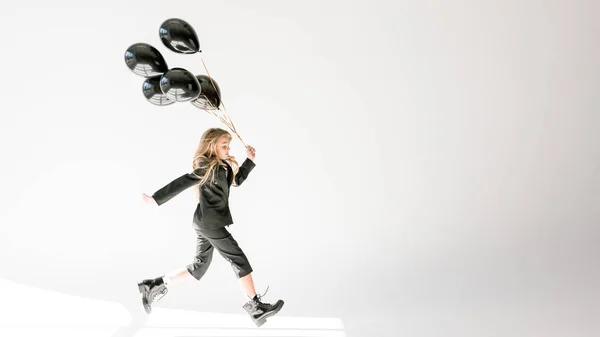 Fashionable Kid Running Black Balloons Grey — Stock Photo, Image