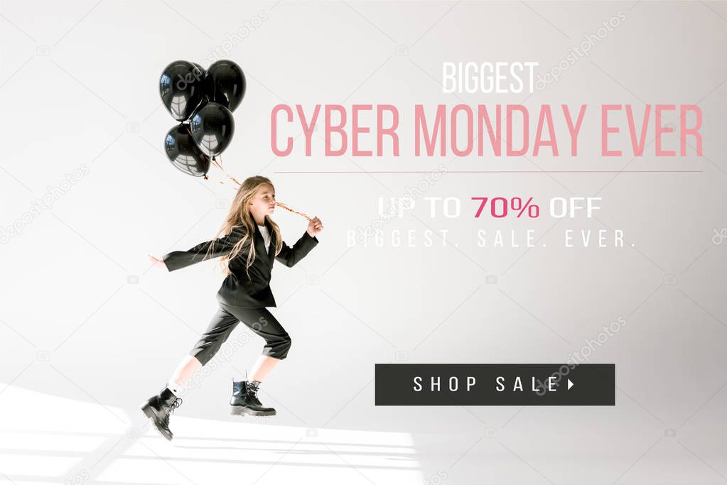 fashionable child in trendy suit jumping with black balloons on grey, black friday sale banner