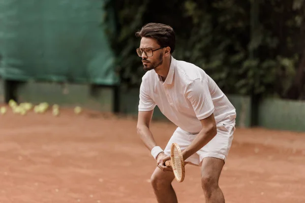 Focused retro styled tennis player during game at tennis court — Stock Photo