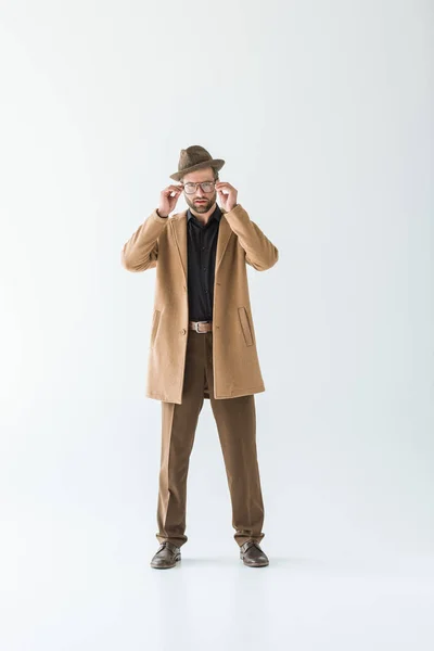 Hombre de moda en abrigo marrón y sombrero, aislado en blanco - foto de stock