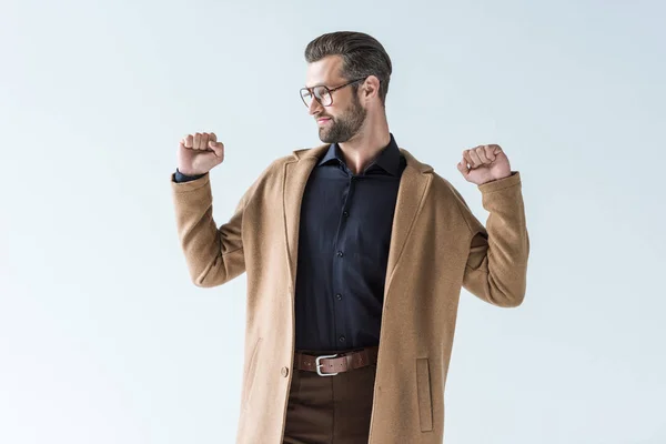 Excited man gesturing and posing in autumn brown coat, isolated on white — Stock Photo