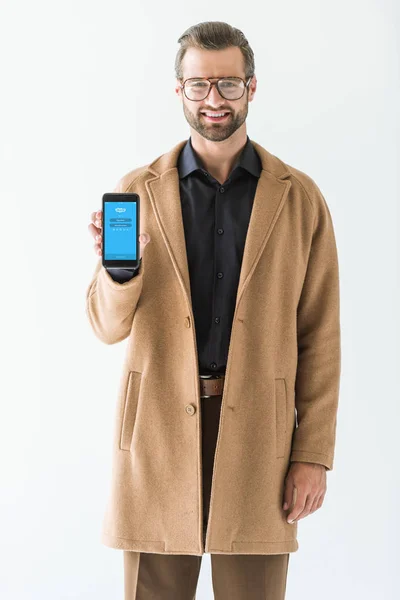 Handsome man presenting smartphone with skype appliance, isolated on white — Stock Photo