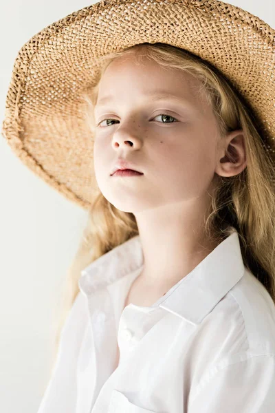 Portrait of beautiful child in straw hat looking at camera on white — Stock Photo
