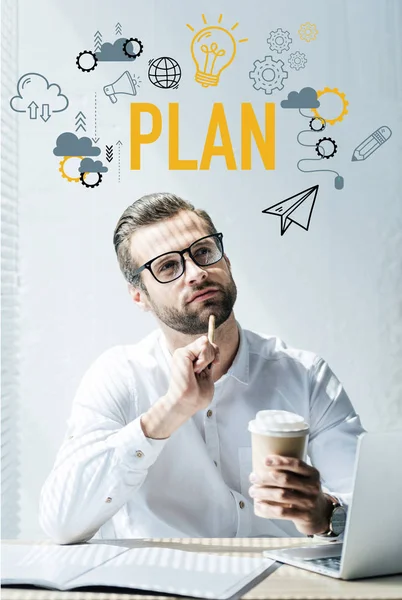 Thoughtful businessman sitting at workplace with plan icons — Stock Photo