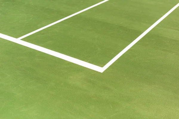 Close up view of green tennis court with white lines background — Stock Photo