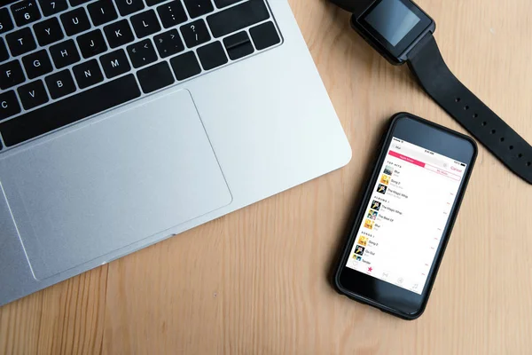 Top view of laptop, smartwatch and smartphone with apple music app on screen — Stock Photo