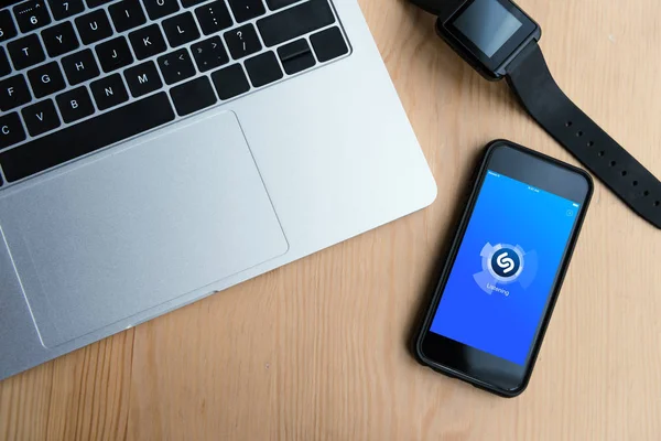 Top view of laptop, smartwatch and smartphone with shazam app on screen — Stock Photo