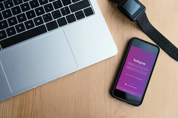 Top view of laptop, smartwatch and smartphone with instagram website on screen — Stock Photo