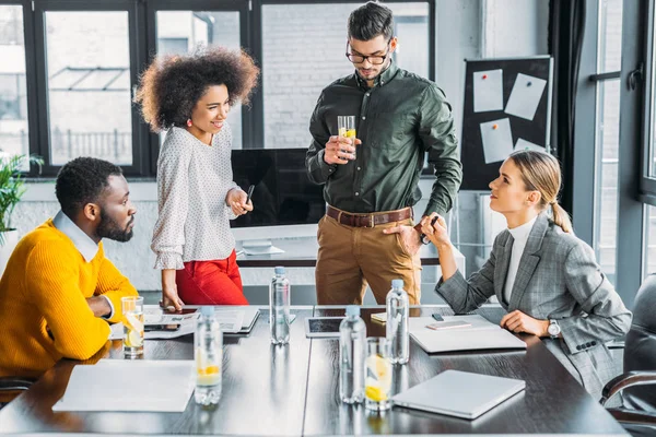 Multicultural colleagues talking during meeting in office — Stock Photo