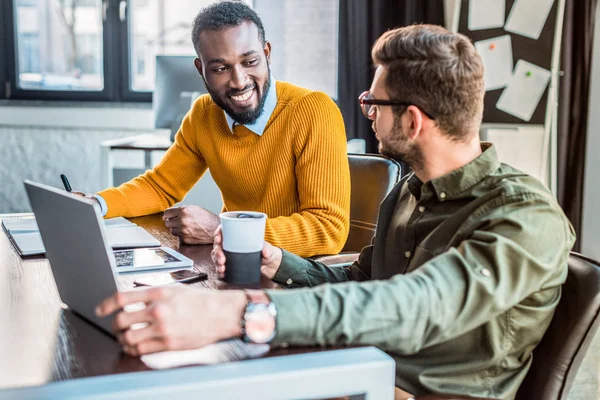 Multicultural businessmen looking at each other in office — Stock Photo