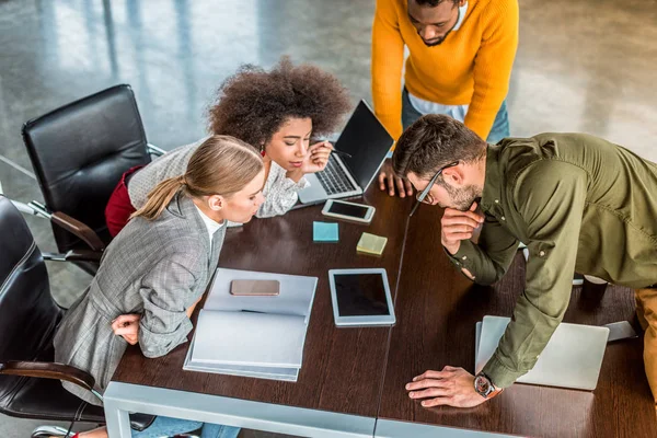 High angle view of multicultural businesspeople looking at tablet in office — Stock Photo