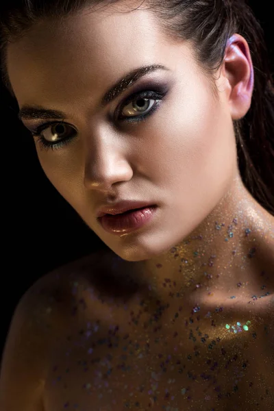 Glamorous model posing with glitter on body for fashion shoot, isolated on black — Stock Photo