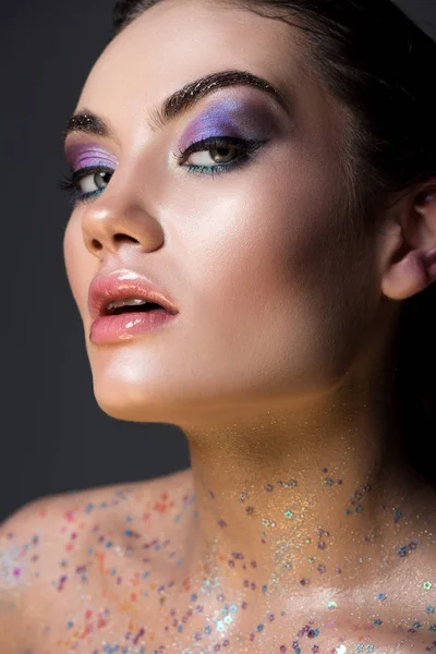 Sensual glamorous girl posing with glitter on body, isolated on grey — Stock Photo