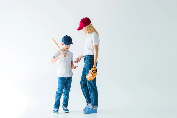 Mother giving baseball ball to son on white — Stock Photo