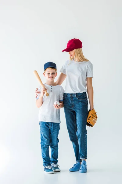 Mother and son holding baseball equipment on white — Stock Photo