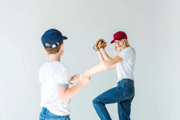 Mother pitching baseball ball to son with baseball bat isolated on white — Stock Photo