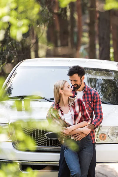 Beautiful smiling couple embracing near white pickup truck — Stock Photo