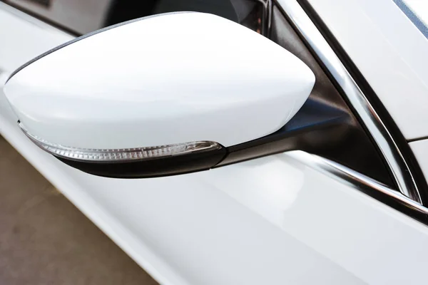 Cropped image of white car side mirror on street — Stock Photo