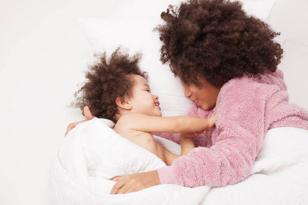 Two little sisters in bed 
