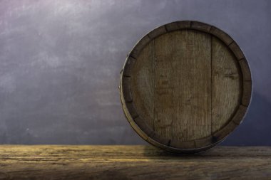 Varil üzerinde eski bir yuvarlak ahşap masa. Güzel koyu arka plan