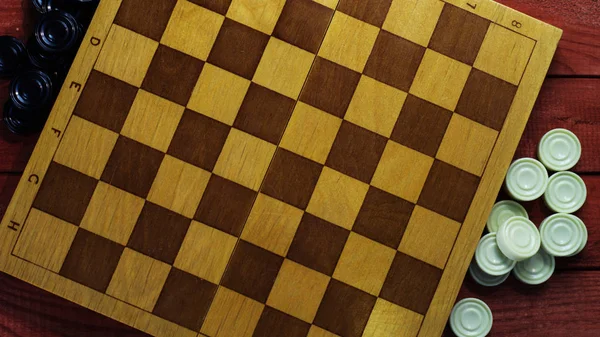Sports or recreation Board game board with checkers. Hobby. Checkers on the playing field for the game.