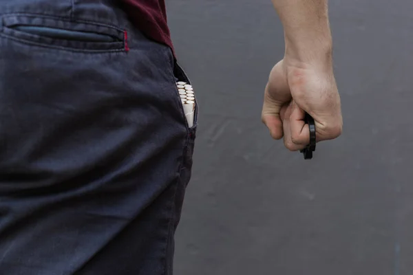 Young Man Holds Brass Knuckles — Stock Photo, Image