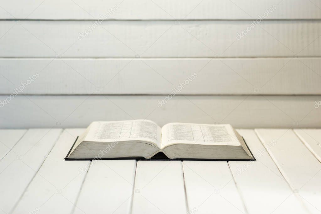 Open Holy Bible on an old table. Beautiful background.Religion concept.