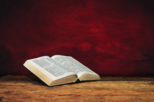 Bible on a old wooden table background.