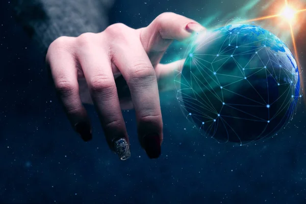 Woman touching planet with finger and network web and blue nebula dust. Mixed media.