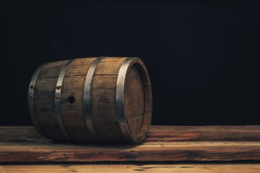 Eski bir meşe masasında ahşap varil. Arkasında siyah arka plan.