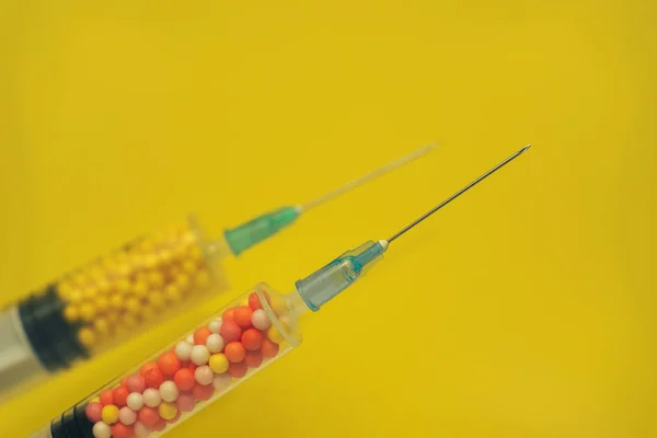 Two Syringe Filled Colorful Nano Balls Yellow Background Innovative Medical — Stock Photo, Image