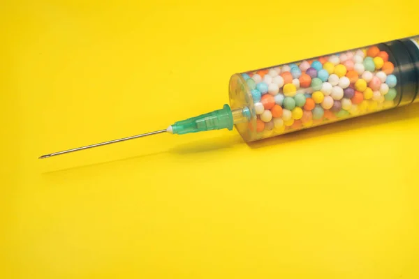 Syringe Filled Colorful Nano Balls Yellow Background Innovative Medical Concept — Stock Photo, Image