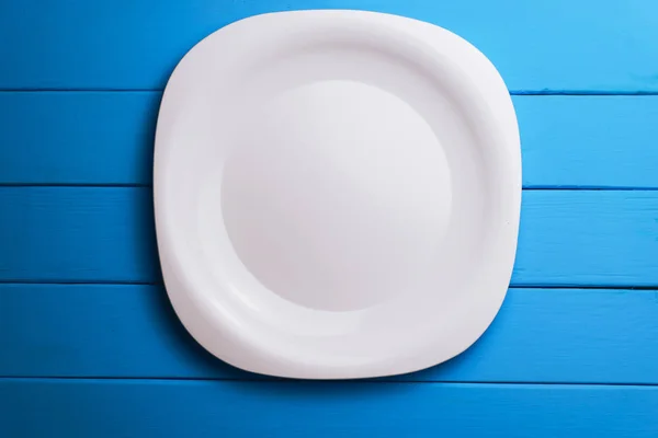 White Plate Blue Wooden Table Background — Stock Photo, Image