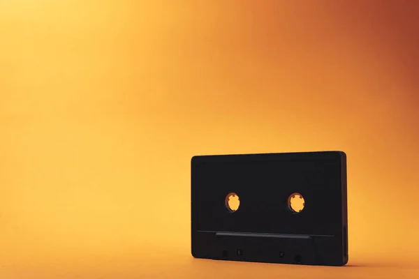Black Classic Magnetic Cassette Tape Orange Background — Stock Photo, Image
