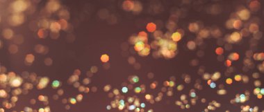 Kahverengi bir arka plan üzerinde güzel altın bokeh.