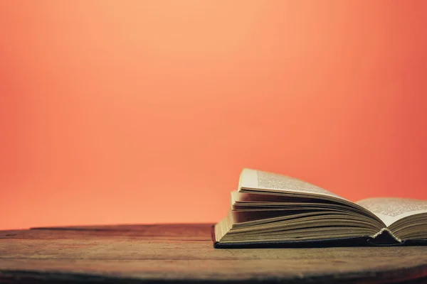 Open Book Old Wooden Table Beautiful Coral Orange Background — Stock Photo, Image