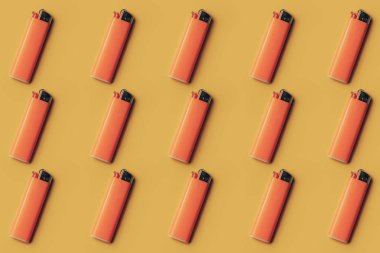  Yaratıcı bir arka plan üzerinde turuncu plastik çakmak.