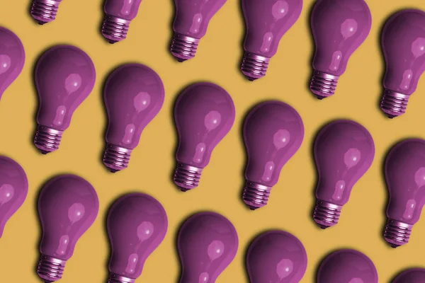 Beautiful purple bulb on a yellow background. Creative Concept Of Retro Style.