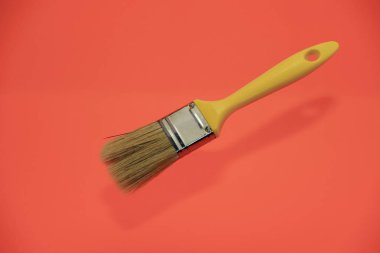 Yaşayan bir mercan arka plan üzerinde yeni sarı boya fırçası.