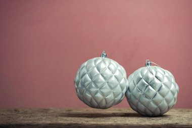 Eski bir ahşap tble ve kırmızı duvar arka plan üzerinde güzel noel gümüş bauble.