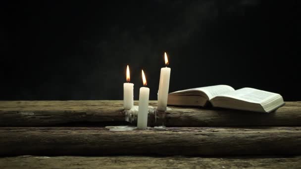 Beautiful Open Bible Burned Candles Old Oak Wooden Table Dark — Stock Video