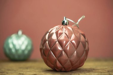 Eski bir meşe ahşap masa ve kırmızı duvar arka plan üzerinde Güzel Noel bauble kapatın.