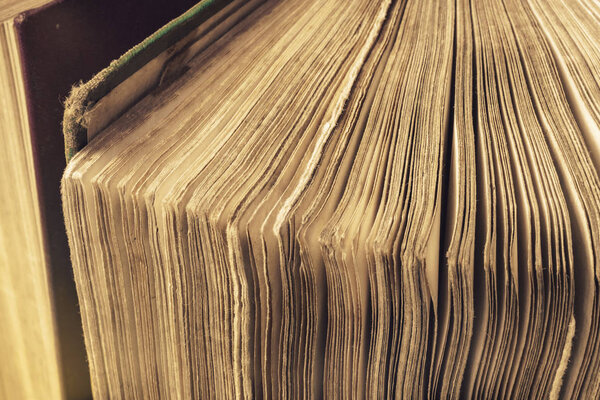 Close up open old page books on a background table. Macro view.
