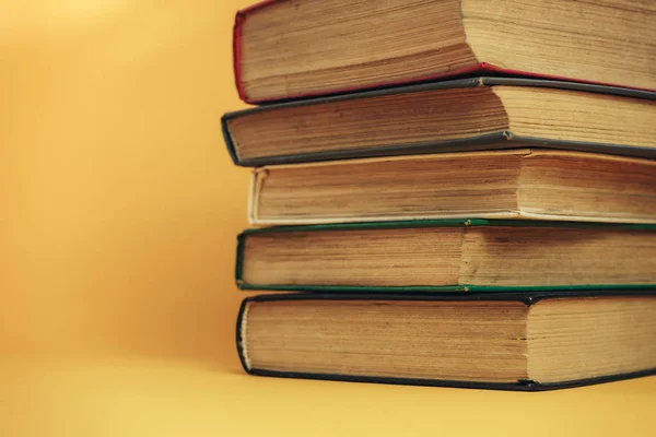 Beautiful old books on a orange background.