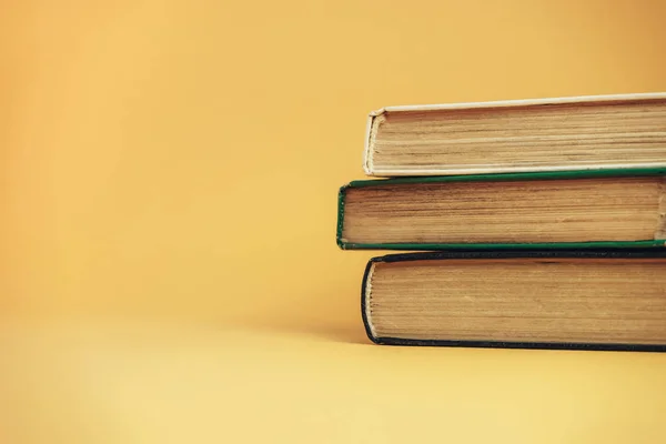 Beautiful old books on a orange background.