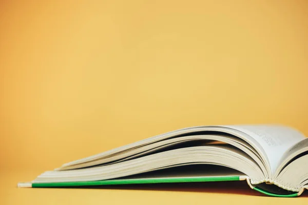 Close up open Beautiful new book on a yellow background.