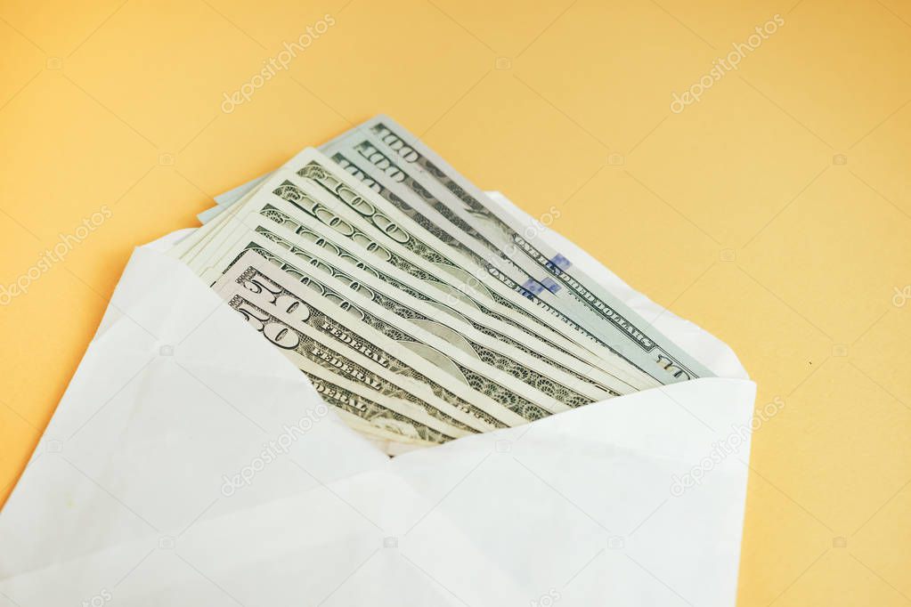 Close up Beautiful Dollars in the envelope on a yellow Background. American, US Dollars Cash Money. One Hundred Dollar Banknotes .