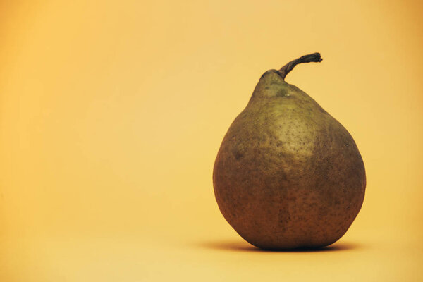 Beautiful on pear on a yellow background.