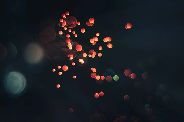 Beautiful red  abstract optical light bokeh in the darkness background.