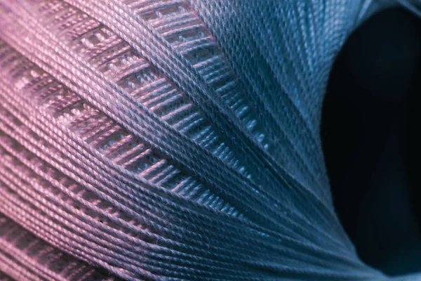 Close up beautiful tangle of thread in red and blue light on a dark background. Macro Photography view.